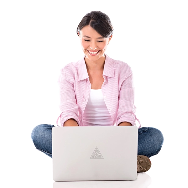 a woman sitting on the floor using a laptop and smiling